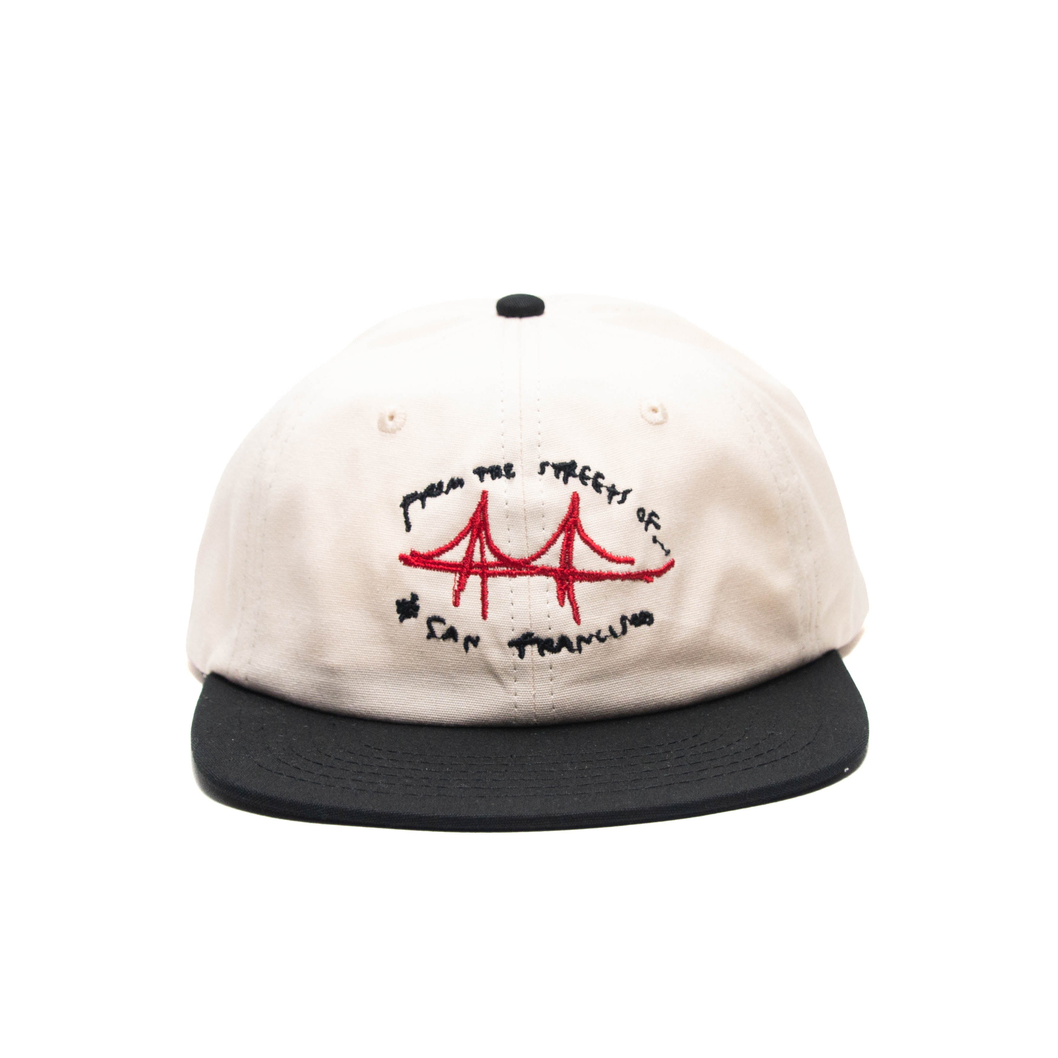 An off-white baseball cap with a black flat brim, featuring a red and black embroidered design on the front that reads 'from the streets of San Francisco' around a red Golden Gate Bridge graphic.